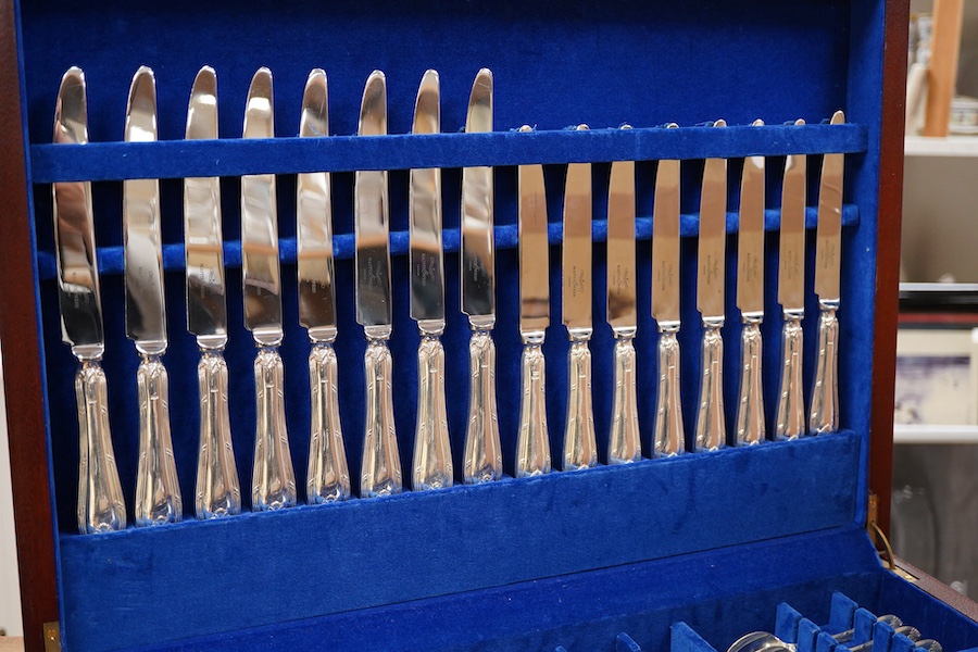 An Elizabeth II canteen of silver cutlery for eight, by Mappin & Webb, comprising table and dessert forks, dessert, soup and teaspoons, silver handled steel table and dessert knives two table or serving spoons and a pair